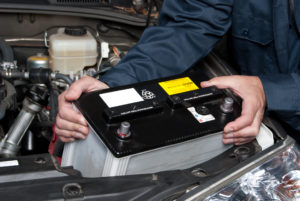 Auto mechanic replacing car battery Lake Arbor Automotive & Truck Westminster Colorado