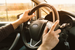 male hands on steering wheel Lake Arbor Automotive & Truck Westminster Colorado